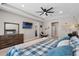 Comfortable main bedroom suite with TV, desk and relaxing decor at 3332 Lone Cypress Pt, Oviedo, FL 32765