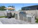Well-equipped outdoor kitchen featuring a built-in grill, refrigerator, and ample counter space for cooking and entertaining at 3332 Lone Cypress Pt, Oviedo, FL 32765
