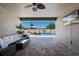 Covered patio with an outdoor seating area and a view of the pool and surrounding landscape at 3332 Lone Cypress Pt, Oviedo, FL 32765