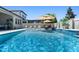 Stunning pool with water features, lush landscaping, and comfortable seating, perfect for relaxation and entertaining at 3332 Lone Cypress Pt, Oviedo, FL 32765