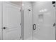 Modern bathroom shower boasts white subway tile, glass door, and black hardware at 3332 Lone Cypress Pt, Oviedo, FL 32765