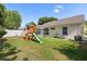 Spacious, well-maintained lawn with a playset and a view of the home's exterior at 342 Hanging Moss Cir, Lake Mary, FL 32746