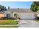 Charming one-story home featuring a manicured lawn and a two-car garage at 342 Hanging Moss Cir, Lake Mary, FL 32746