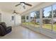 Bright sunroom with tile floors and multiple windows overlooking the backyard with playground equipment at 342 Hanging Moss Cir, Lake Mary, FL 32746