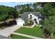 An aerial view of a lovely home with mature trees, a green lawn and 2-car garage at 3562 Gatlin Pl, Orlando, FL 32812