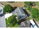 An aerial view captures the well-maintained home, showcasing its roof and surrounding mature trees on a corner lot at 3562 Gatlin Pl, Orlando, FL 32812