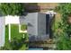 An aerial view of a home with a gray roof, well-maintained lawn, patio, and mature trees at 3562 Gatlin Pl, Orlando, FL 32812
