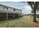 A spacious backyard with large tree and screened porch for outdoor enjoyment at 3562 Gatlin Pl, Orlando, FL 32812