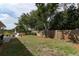 A lush backyard featuring a privacy fence and mature trees at 3562 Gatlin Pl, Orlando, FL 32812