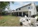 A backyard patio with pavers and lawn, perfect for entertaining and relaxing at 3562 Gatlin Pl, Orlando, FL 32812