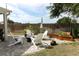 A stone patio with a fire pit and chairs at 3562 Gatlin Pl, Orlando, FL 32812