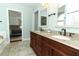 Elegant bathroom with a double sink vanity and a soaking tub at 3562 Gatlin Pl, Orlando, FL 32812