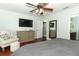 Serene bedroom with neutral tones, a ceiling fan, and ample closet space at 3562 Gatlin Pl, Orlando, FL 32812