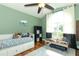 Cozy bedroom with large window, ceiling fan, and hardwood floors at 3562 Gatlin Pl, Orlando, FL 32812