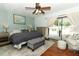 Cozy bedroom with a ceiling fan, outdoor access, and stylish decor at 3562 Gatlin Pl, Orlando, FL 32812