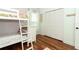 Charming bedroom with hardwood floors, bunk beds, and a spacious closet at 3562 Gatlin Pl, Orlando, FL 32812