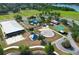 A community park features a splash pad, playground, sand volleyball court, and pavilion on a sunny day at 3562 Gatlin Pl, Orlando, FL 32812