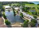 A community park features a splash pad, playground, sand volleyball court, pavilion and pond on a sunny day at 3562 Gatlin Pl, Orlando, FL 32812