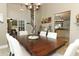 Spacious dining room featuring a large wood table, seating for six, and an elegant chandelier at 3562 Gatlin Pl, Orlando, FL 32812