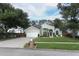 Beautiful house exterior with a two-car garage, pretty landscaping and green lawn at 3562 Gatlin Pl, Orlando, FL 32812