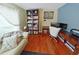 Cozy home office with a comfortable couch, wooden desk, and built-in bookcase for organization at 3562 Gatlin Pl, Orlando, FL 32812