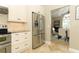 Open concept kitchen featuring granite countertops, stainless appliances, and a pass through to the dining room at 3562 Gatlin Pl, Orlando, FL 32812