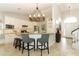 Open kitchen featuring granite countertops, stainless appliances, breakfast bar, and a view of the staircase at 3562 Gatlin Pl, Orlando, FL 32812