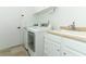 Well-lit laundry room equipped with a sink and modern appliances at 3562 Gatlin Pl, Orlando, FL 32812