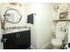 Stylish powder room with modern fixtures and decorative wallpaper at 3562 Gatlin Pl, Orlando, FL 32812