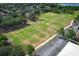 Aerial view of a well maintained soccer field and parking lot surrounded by lush greenery and trees in the area at 3562 Gatlin Pl, Orlando, FL 32812