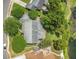 An aerial view shows the house with mature trees, lawn and pond in the backyard at 3605 Pershing Ave, Orlando, FL 32812