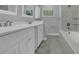 Well-lit bathroom with double vanity, tub and shower combination, and tiled floors at 3605 Pershing Ave, Orlando, FL 32812