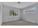 Neutral painted bedroom with hardwood floors, carpet, and two windows allowing for ample natural light at 3605 Pershing Ave, Orlando, FL 32812