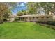 Charming single-story home with manicured lawn, mature landscaping, and attached garage at 3605 Pershing Ave, Orlando, FL 32812