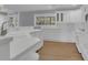Bright kitchen featuring white cabinets, white appliances, and plenty of counter space at 3605 Pershing Ave, Orlando, FL 32812