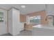 Bright laundry room featuring white cabinets, tile floors, and a window for natural light at 3605 Pershing Ave, Orlando, FL 32812