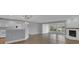 Open-concept kitchen and living area with hardwood floors and a cozy fireplace at 3605 Pershing Ave, Orlando, FL 32812