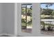 Patio through the glass doors that offers gorgeous views of the lake and surrounding yard and foliage at 3605 Pershing Ave, Orlando, FL 32812