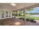 Inviting screened porch with brick flooring and serene water view, perfect for enjoying the outdoors at 3605 Pershing Ave, Orlando, FL 32812