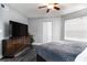 Comfortable bedroom with a ceiling fan, large TV, and sleek wood dresser at 3807 Atrium Dr, Orlando, FL 32822