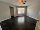 Bright bedroom with dark wood flooring and a ceiling fan at 3807 Atrium Dr, Orlando, FL 32822