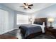 Cozy bedroom with a ceiling fan, window with blinds, and modern wood furniture at 3807 Atrium Dr, Orlando, FL 32822