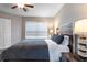 Comfortable bedroom featuring a ceiling fan, and a large bed with plush bedding at 3807 Atrium Dr, Orlando, FL 32822