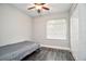 Bright bedroom with a ceiling fan, closet, and a large window with light coming through at 3807 Atrium Dr, Orlando, FL 32822