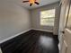 Bright bedroom with dark wood flooring and a ceiling fan at 3807 Atrium Dr, Orlando, FL 32822