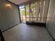A serene enclosed patio with tiled floor, wood paneling, and view of lush greenery outside at 3807 Atrium Dr, Orlando, FL 32822