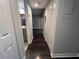 Hallway featuring nice dark wood flooring, leading to a bathroom and another room at 3807 Atrium Dr, Orlando, FL 32822
