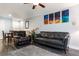 Open-concept living and dining area with stylish gray floors and comfortable leather seating at 3807 Atrium Dr, Orlando, FL 32822