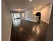 Open-concept living space with stylish gray floors, kitchen, and sliding glass doors at 3807 Atrium Dr, Orlando, FL 32822
