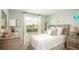 Bright bedroom with a large window, light walls, a decorative headboard, and beautiful matching dressers at 3824 Bluethread Way, Poinciana, FL 34759